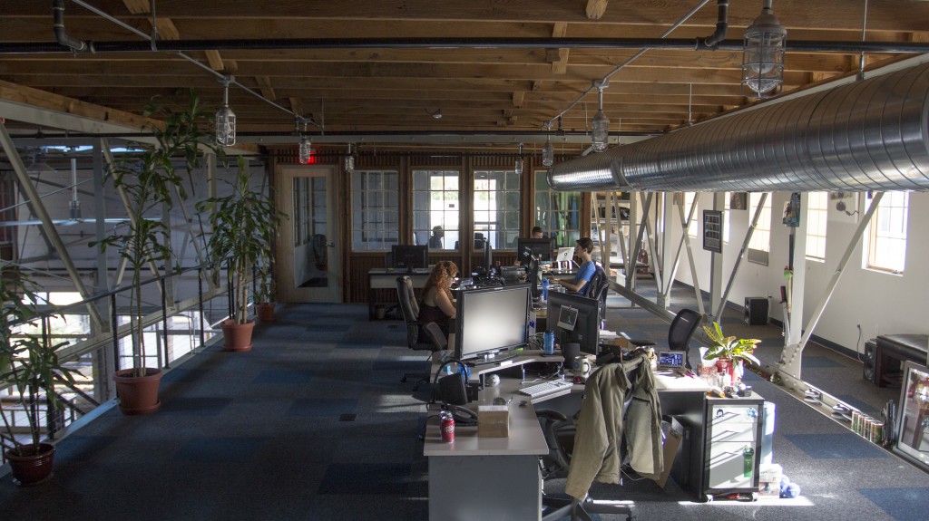 An open loft section where some of the iFixit team works. Note the gorgeous wood ceiling.